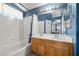 Bathroom featuring dual sinks, bathtub/shower combo, and blue accent walls at 1301 Nugget Creek Dr, Las Vegas, NV 89108