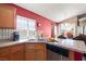 Sunlit kitchen featuring granite countertops, stainless steel sink, and updated fixtures at 1301 Nugget Creek Dr, Las Vegas, NV 89108