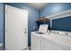 Convenient laundry room with washer, dryer, and built-in shelving at 1301 Nugget Creek Dr, Las Vegas, NV 89108