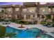 A resort-style backyard features a pool with a spa, desert landscaping, and lounge seating at 1472 Macdonald Ranch Dr, Henderson, NV 89012