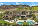 Modern home featuring a pool, spa, multiple patios, lush landscaping, and beautiful stone accents at 1472 Macdonald Ranch Dr, Henderson, NV 89012