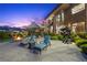 A backyard area with outdoor seating, a fire pit and manicured landscaping at 1472 Macdonald Ranch Dr, Henderson, NV 89012