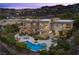 Aerial view of a modern home with a pool, spa, multiple patios, and lush landscaping at 1472 Macdonald Ranch Dr, Henderson, NV 89012