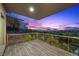 Balcony view of a green golf course and the city during a colorful sunset at 1472 Macdonald Ranch Dr, Henderson, NV 89012