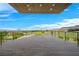 A covered balcony with views of the golf course and mountains beyond at 1472 Macdonald Ranch Dr, Henderson, NV 89012