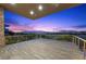 Expansive balcony boasting sweeping city and golf course views during a vibrant sunset at 1472 Macdonald Ranch Dr, Henderson, NV 89012