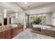 Upscale bathroom with a soaking tub, dual vanities, and private garden view at 1472 Macdonald Ranch Dr, Henderson, NV 89012