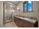 Bathroom features double vanity sinks and separate glass shower at 1472 Macdonald Ranch Dr, Henderson, NV 89012
