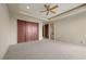 Spacious bedroom with carpet, ceiling fan, walk-in closet, and ensuite bathroom access at 1472 Macdonald Ranch Dr, Henderson, NV 89012