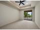 Bright bedroom features a ceiling fan and sliding glass doors to the outdoor space at 1472 Macdonald Ranch Dr, Henderson, NV 89012