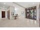 Spacious entryway featuring an accent table with floral arrangement and decorative glass front doors at 1472 Macdonald Ranch Dr, Henderson, NV 89012
