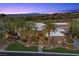 Stunning twilight view of a modern home enhanced by palm trees and manicured landscaping at 1472 Macdonald Ranch Dr, Henderson, NV 89012