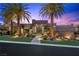Contemporary home showcasing clean lines, stone accents, mature palm trees and professional landscaping at 1472 Macdonald Ranch Dr, Henderson, NV 89012