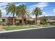 Beautifully landscaped front yard with mature palm trees enhances this contemporary home's curb appeal at 1472 Macdonald Ranch Dr, Henderson, NV 89012