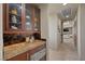 Butlers pantry with granite countertops and rich wood cabinetry at 1472 Macdonald Ranch Dr, Henderson, NV 89012