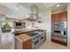 Modern kitchen boasting stainless steel Viking appliances, gas range, and tile flooring at 1472 Macdonald Ranch Dr, Henderson, NV 89012