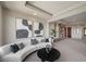 Open concept living room with modern art, fireplace, recessed lights, and a curved sofa at 1472 Macdonald Ranch Dr, Henderson, NV 89012