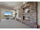 Modern living room with stone fireplace, large windows, recessed lighting, and neutral furniture at 1472 Macdonald Ranch Dr, Henderson, NV 89012