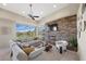 Comfortable living room with stone fireplace, large windows offering scenic views at 1472 Macdonald Ranch Dr, Henderson, NV 89012