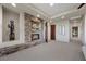 Spacious living room with stone fireplace, recessed lighting, and hardwood floors leading into hallway at 1472 Macdonald Ranch Dr, Henderson, NV 89012