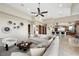 Spacious living room with modern decor, tile flooring, and seamless flow to kitchen at 1472 Macdonald Ranch Dr, Henderson, NV 89012