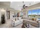 Open concept living room featuring views of the kitchen, expansive windows, and a plush sectional sofa at 1472 Macdonald Ranch Dr, Henderson, NV 89012