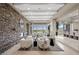 Elegant living room with a stone fireplace, neutral furniture, and golf course views at 1472 Macdonald Ranch Dr, Henderson, NV 89012