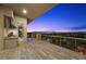 A covered patio features a built-in outdoor kitchen and scenic views at 1472 Macdonald Ranch Dr, Henderson, NV 89012