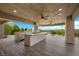 Spacious outdoor kitchen featuring a built-in grill, island, and ceiling fans at 1472 Macdonald Ranch Dr, Henderson, NV 89012
