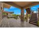 Outdoor patio area with metal stairs, stone columns and pool views at 1472 Macdonald Ranch Dr, Henderson, NV 89012