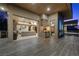 Modern patio with outdoor kitchen, comfortable seating, and seamless indoor-outdoor living with sliding glass doors at 1472 Macdonald Ranch Dr, Henderson, NV 89012