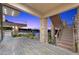 A multi-level patio area with metal stairs, stone columns and sunset views at 1472 Macdonald Ranch Dr, Henderson, NV 89012