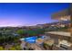A luxurious pool and spa overlook a lush green golf course and mountain views at 1472 Macdonald Ranch Dr, Henderson, NV 89012
