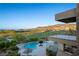 A luxurious pool and spa overlook a lush green golf course and mountain views at 1472 Macdonald Ranch Dr, Henderson, NV 89012