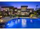 Stunning backyard oasis featuring a large pool, lounge seating and landscaped grounds of this modern home at 1472 Macdonald Ranch Dr, Henderson, NV 89012