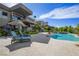 Beautiful backyard with a pool, spa, and lounge seating offers a perfect outdoor retreat and modern landscape at 1472 Macdonald Ranch Dr, Henderson, NV 89012