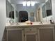 Bathroom featuring dual sinks, large mirrors, and neutral walls at 1851 Hillpointe Rd # 2621, Henderson, NV 89074