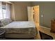 Well-lit bedroom showcasing a comfortable bed, wood floors, and a view to the hallway at 1851 Hillpointe Rd # 2621, Henderson, NV 89074