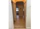 Hallway with tile flooring, neutral walls, and arches that lead to the kitchen at 1851 Hillpointe Rd # 2621, Henderson, NV 89074