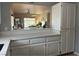 Open kitchen counter, with white cabinets, quartz counter tops and view into the living room at 1851 Hillpointe Rd # 2621, Henderson, NV 89074