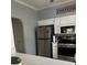 Galley kitchen with stainless steel appliances, quartz countertops, and white cabinets at 1851 Hillpointe Rd # 2621, Henderson, NV 89074