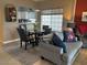 Inviting living room with a dining table, plush seating, and bright natural light at 1851 Hillpointe Rd # 2621, Henderson, NV 89074