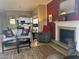 Stylish living room featuring a comfortable sofa, fireplace, and view to kitchen at 1851 Hillpointe Rd # 2621, Henderson, NV 89074