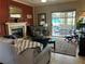 Cozy living room featuring fireplace, hardwood floors, and access to a patio at 1851 Hillpointe Rd # 2621, Henderson, NV 89074