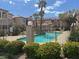 Community pool area with clear water, surrounded by lush landscaping and fencing at 1851 Hillpointe Rd # 2621, Henderson, NV 89074