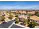 Expansive aerial view featuring a suburban community with tile roofs, desert landscape, and distant city skyline at 2434 Amoretti St, Henderson, NV 89052