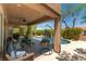 Inviting covered patio with comfortable seating and hanging chair, overlooking a pristine pool area at 2434 Amoretti St, Henderson, NV 89052