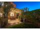 Charming backyard at twilight featuring a pergola-covered patio, perfect for evening relaxation and entertaining at 2434 Amoretti St, Henderson, NV 89052