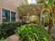 Charming backyard with lush foliage, a pergola, and outdoor seating at 2434 Amoretti St, Henderson, NV 89052