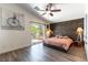 Bedroom with a sliding glass door to a balcony and a decorative wood panel wall at 2434 Amoretti St, Henderson, NV 89052